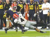  ?? CURTIS COMPTON/ASSOCIATED PRESS ?? Georgia’s Nolan Smith tackles Michigan quarterbac­k J.J. McCarthy during the teams’ playoff semifinal on New Year’s Eve.