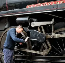  ??  ?? Andrew Pooley checks out the locomotive Braveheart, built in 1951. After falling into disrepair, it was brought back to steam in 1994 and acquired by the Dartmouth railway company in 2002. Following a major overhaul, the train returned to service in 2016.