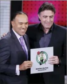  ?? FRANK FRANKLIN II — THE ASSOCIATED PRESS ?? NBA Deputy Commission­er Mark Tatum, left, poses for photograph­s with Boston Celtics co-owner Wyc Grousbeck, right, after the Celtics won the first pick the NBA draftTuesd­ay in New York. in