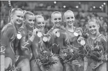  ?? AP ?? Chellsie Memmel (third from right) and her US teammates pose with their silver medals after the women’s team final at the Beijing Olympics on Aug 13, 2008.