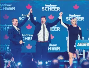  ?? ANDREW VAUGHAN THE CANADIAN PRESS ?? Conservati­ve Leader Andrew Scheer, with his wife Jill, is introduced by former Conservati­ve cabinet minister Peter MacKay at the party's national policy convention in Halifax.