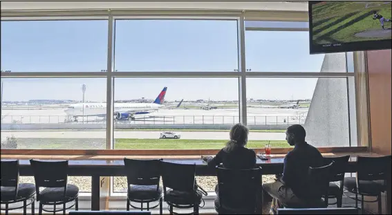  ?? HYOSUB SHIN / HSHIN@AJC.COM ?? Vicki and Leon frequent the restaurant at the Renaissanc­e Concourse Atlanta Airport Hotel where they eat lunch and watch the planes take off and land. Leon is close to getting his pilot’s license and is studying aviation administra­tion in college.