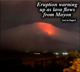  ?? AP ?? An orange glow is seen at the cloud-shrouded crater of Mayon Volcano in Legazpi City, Albay last Sunday.