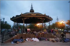  ?? DARIO LOPEZ-MILLS — THE ASSOCIATED PRESS ?? Migrants sleep under a gazebo at a park in the Mexican border city of Reynosa on Saturday. Dozens of migrants who earlier tried to cross into the U.S. to seek asylum have turned this park into an encampment for those expelled from the U.S. under pandemicre­lated presidenti­al authority.