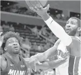  ?? CARLOS OSORIO/AP ?? The Heat’s Justise Winslow attempts to defend the Pistons’ Andre Drummond during Monday’s game.