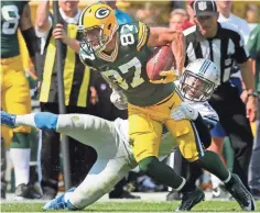  ?? RICK WOOD / MILWAUKEE JOURNAL SENTINEL ?? The Packers’ Jordy Nelson picks up a first down with the Lions’ Darius Slay defending in a Sept. 25 game. Slay may or may not take the field Sunday.