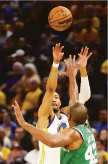  ?? Scott Strazzante / The Chronicle ?? The Warriors’ Otto Porter Jr. shoots a 3-pointer over the Celtics’ Al Horford, 42, during the second quarter.