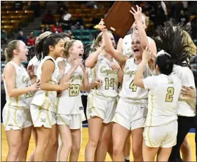  ?? ALISSA NOE — BOCOPREPS.COM ?? Members of the Monarch girls basketball team celebrate the program’s Class 6A Great 8victory over Regis Jesuit on Saturday morning at the Denver Coliseum.