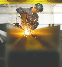  ?? ED KAISER / Postmedia News Files ?? Welder/fitter Nenad Vojvodic grinds an I-beam at Supreme Steel. In a highly unusual move in August, Finance Minister Bill Morneau granted full duty remissions on the components for both LNG Canada and Woodfibre LNG.