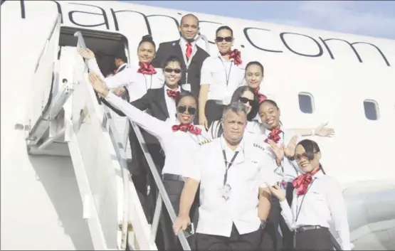  ?? (Stabroek News file photo) ?? Local representa­tive of Dynamic Airways Captain Gerry Gouveia (left at front) with some of the airline’s flight attendants in more prosperous times for the entity.