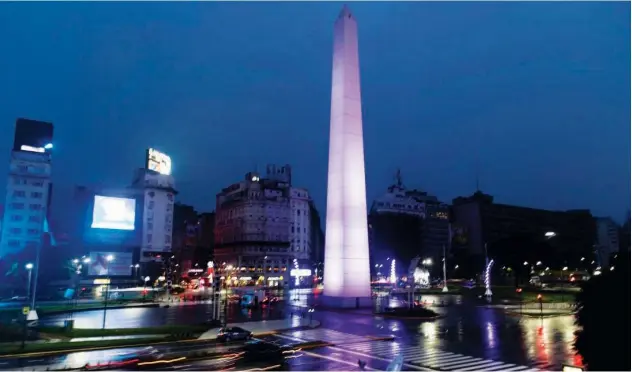  ?? Associated Press ?? ↑ Cars drive on the 9 de Julio Ave past the illuminate­d Obelisk monument in Buenos Aires.