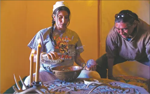  ?? COURTESY PHOTO ?? Wumaniti founders Gemma Ra’Star and Elliot LeftHand prepare to grind up cannabis.