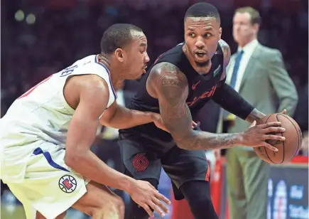  ?? ROBERT HANASHIRO/USA TODAY SPORTS ?? Trail Blazers guard Damian Lillard, defended by Clippers guard Avery Bradley, is averaging a career-high 27.3 points to go with 5.0 rebounds and 6.0 assists this season.