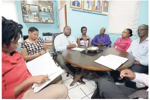  ??  ?? The Rev Claude Ellis (third left), principal of the Pembroke Hall High School, is flanked by members of the senior management team, which has been guiding the improved performanc­e of the school.