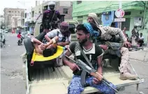  ??  ?? Pro-government fighters rush a comrade to the hospital after he was injured in clashes with Houthi fighters in Taez on Thursday.