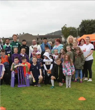  ??  ?? Family fun day is a success as children in Cranmore learn to play cricket with help of Irish player