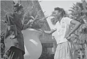  ?? LIBRARY OF CONGRESS ?? Students chat between classes on the Bethune-Cookman College campus during wartime in 1943. The woman at left is dressed for a National Youth Administra­tion class in welding.