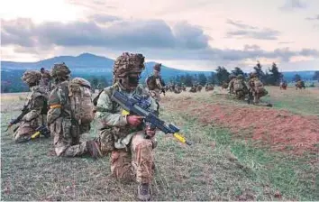  ?? AFP ?? British soldiers take position during a simulated military exercise with the Kenya Defence Forces at the Ol Daiga ranch, in Lolldaiga Hills.