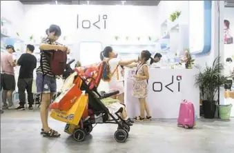  ?? Giulia Marchi/The New York Times ?? A woman shops at the Children Baby Maternity Expo on July 27 in Shanghai.