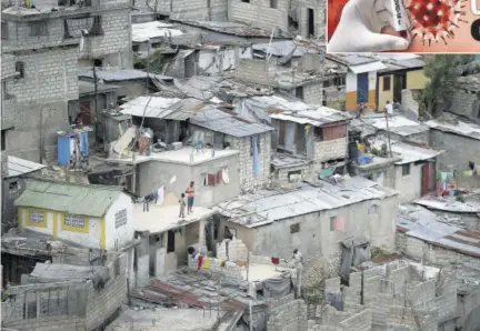  ?? (Photo: AP) ?? Neighbours stand on a roof in Port-au-prince, Haiti, on July 12, 2021.