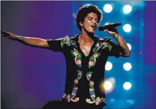  ?? Florent Déchard CBS ?? Bruno Mars during a taping of his first prime-time television special. Mars sang a rendition of “My Heart Will Go On” Saturday night that will never be seen by people who weren’t there. Mars “pockets” cellphones during his performanc­es.