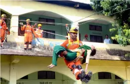  ?? — PTI ?? Disaster Management personnel carry out a mock drill at a school in Sonitpur, Assam, on Friday.