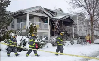  ?? ANDREA PEACOCK/The Daily Courier ?? Kelowna fire crews investigat­e a fire at a townhouse complex in the 1200 block of Cameron Avenue Wednesday morning. The blaze, which was discovered by a Kelowna RCMP officer, damaged six units.