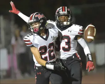  ?? Dan Watson/The Signal (See additional photos on signalscv.com) ?? Hart’s Drew Munoz (22) and Ashton Thomas (33) celebrate after a Hart touchdown in the first quarter against West Ranch at Valencia High School on Saturday.