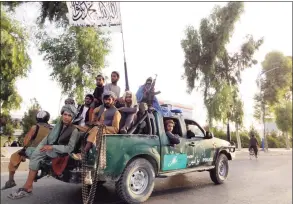  ?? Sidiqullah Khan / Associated Press ?? Taliban fighters patrol inside the city of Kandahar, southwest Afghanista­n, on Sunday.