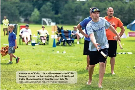  ?? ALEXANDRA WIMLEY/USA TODAY NETWORK-WISCONSIN ?? A member of Kubb Life, a Milwaukee-based Kubb league, tosses the baton during the U.S. National Kubb Championsh­ip in Eau Claire on July 15.