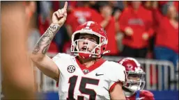  ?? HYOSUB SHIN/ HYOSUB.SHIN@ AJC.COM ?? Carson Beck celebrates a touchdown against Alabama on a 1-yard run during the SEC Championsh­ip game Dec. 2 at Mercedes-benz Stadium. Beck threw for 3,973 yards and 25 touchdowns, leading UGA to a 12-1 season.