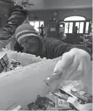  ?? ?? Brian Lindberg packs snacks for people in need at Miss Carly’s.