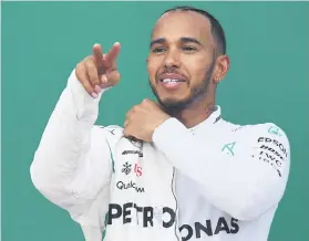  ?? Picture: AFP. ?? REWARDED. Lewis Hamilton stayed out of trouble, inheriting both the race victory and world championsh­ip lead.