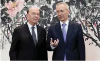  ?? – Reuters ?? CRUCIAL MEETING: US Commerce Secretary Wilbur Ross, left, with Chinese Vice Premier Liu He after their meeting at the Diaoyutai State Guesthouse in Beijing, China on Sunday.