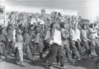  ?? Jean Vincent / AFP / Getty Images 1966 ?? Chinese Red Guards and other students wave Mao Zedong’s “Little Red Book” in Beijing.