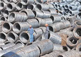  ?? EPA- EFE ?? Workers inspect rolls of steel in China, which suggested retaliatio­n against American products in response to Trump’s tariff plan.