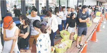  ?? — Reuters photo ?? People line up to buy food outside a store after an earthquake hit the area in Sapporo, Hokkaido.