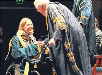  ??  ?? Karen Darke MBE receives her honorary degree. Pictures: Mhairi Edwards.