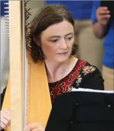  ??  ?? Harpist Ann Marie O’Farrell performing with the Fairfield County Children’s Choir in The Tholsel.