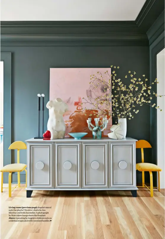  ??  ?? Living room (previous page) Angela’s mural suits the playful ‘Etcetera’ chairs by Jan Ekselius and bold chandelier. A photograph by Matt Odom hangs above the fireplace Above A painting by Angela’s children rests on a sideboard upscaled with oversized handles