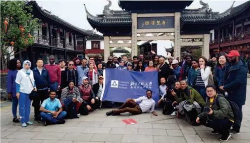  ??  ?? Students from the Emerging Market Institute of Beijing Normal University pose for a group photo in Zhouzhuang, an ancient town in Kunshan, Jiangsu Province. by Zhou Xin