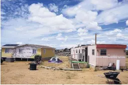  ??  ?? The new home on the left, built by military members through a Southwest Indian Foundation program, will replace a Native American veteran’s current mobile home.