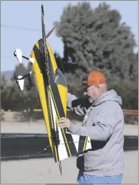  ?? ?? RIGHT: Wayne Bolin carries his Skyway Edge 540T to the flight line Thursday morning.