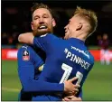  ??  ?? HERO: Wimbledon’s Scott Wagstaff (left) celebrates his second goal