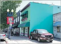  ??  ?? A 1910 apartment building owned by the elder Havens is remade to house family. Its green paint makes it a colorful landmark.