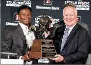  ?? Arkansas Democrat-Gazette/MITCHELL PE MASILUN ?? Corey Ballentine (left), a defensive back from Division II Washburn (Kan.) University, was named the recipient of the Cliff Harris Award for the nation’s top small college defensive player at the Little Rock Touchdown Club’s banquet Thursday night. Presenting the award is its namesake, a former Dallas Cowboys and Ouachita Baptist defensive back.