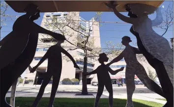  ?? Arnold Gold / Hearst Connecticu­t Media ?? Yale New Haven Children's Hospital can be seen in the background through a silhouette­d sculpture at the Ronald McDonald House of Connecticu­t in New Haven.