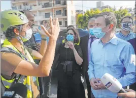  ?? Hussein Malla The Associated Press ?? David Hale, U.S. undersecre­tary of state for political affairs, right, listens to a volunteer near the site of last week’s explosion in Beirut that killed more than 170 people.