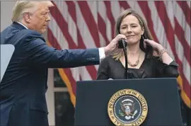  ?? PRESIDENT TRUMP Alex Brandon Associated Press ?? and Judge Amy Coney Barrett at the Rose Garden event announcing her high court nomination, where the coronaviru­s may have spread.