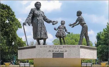  ?? The Washington Post via Getty Images ?? THE MARY McLeod Bethune statue in Lincoln Park in Washington, D.C., above. Kerry James Marshall’s stained glass windows for the National Cathedral, with Alexander’s poem “American Song” below them.